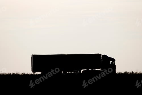 Preview: Silhouette Of A Lorry Passing Through The Field