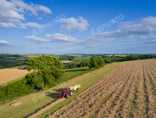 Preview: Aerial View Of Tractor Baling Hay In Field