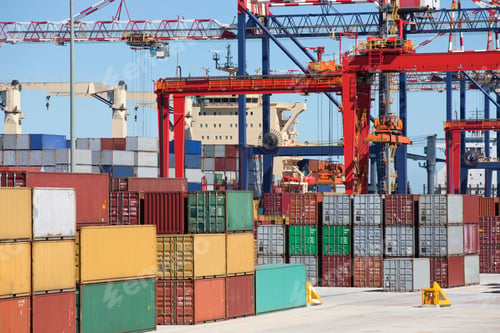 Preview: Cargo Containers And Cranes Alongside A Container Ship Moored At A Commercial Dock.