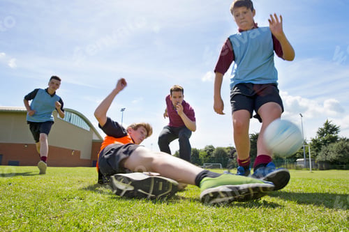 Preview: Wide Shot Of Middle Schoolboys Playing Soccer On Sunny Field In Physical Education Class