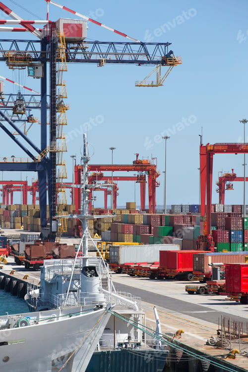 Preview: Vertical Wide Shot Of A Commercial Harbor With Trucks, Cranes And Cargo Containers.