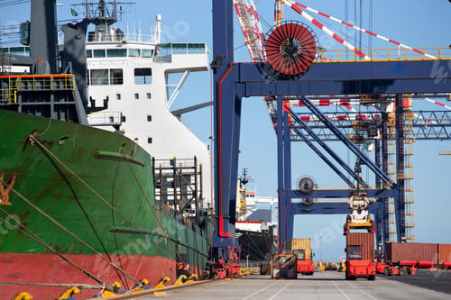 Preview: Wide Shot Of A Crane Loading Cargo Containers Onto A Container Ship At A Commercial Dock.