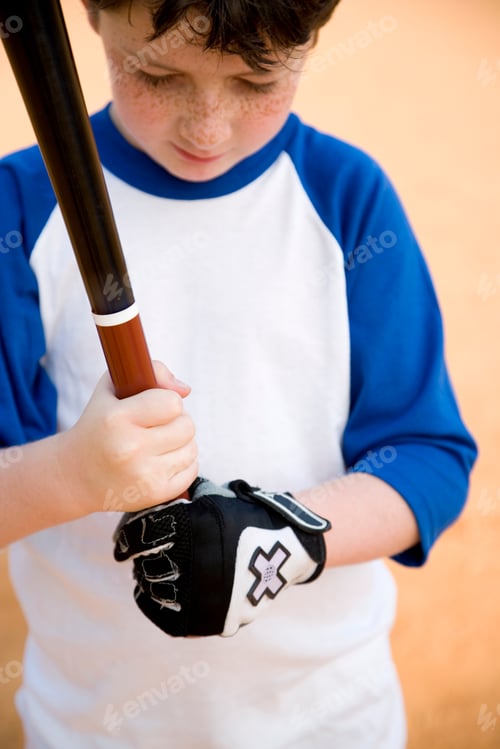 Preview: Boy Holding Baseball Bat Standing On A Field