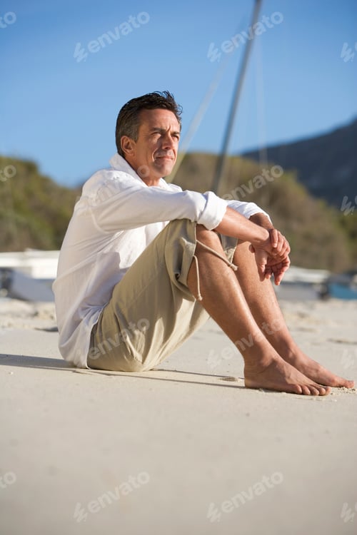 Preview: A Man Sitting On A Beach