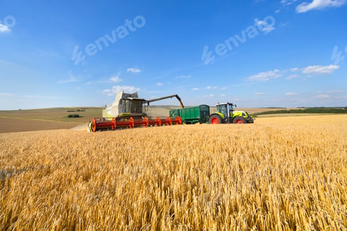 Preview: Combine Harvester Filling Trailer In A Sunny Barley Field