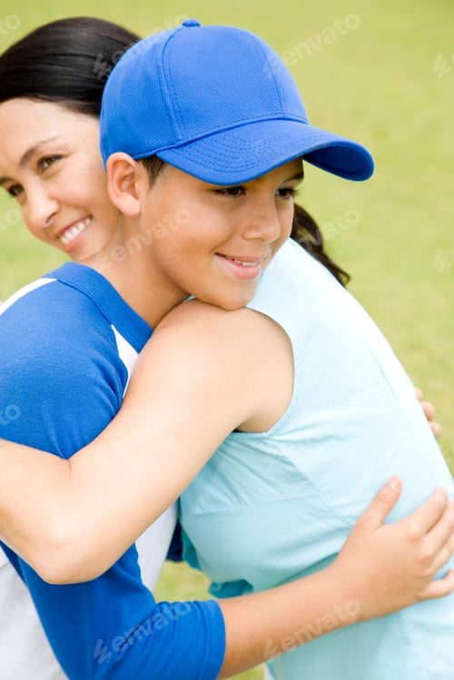 Preview: Mother Hugging Son In Baseball Gear