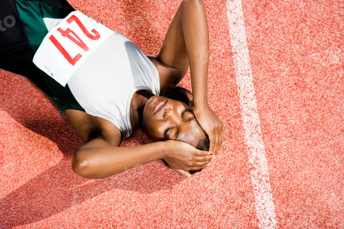 Preview: Female Athlete Resting On A Running Track