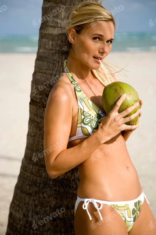 Preview: A Young Woman In A Bikini Standing On A Beach