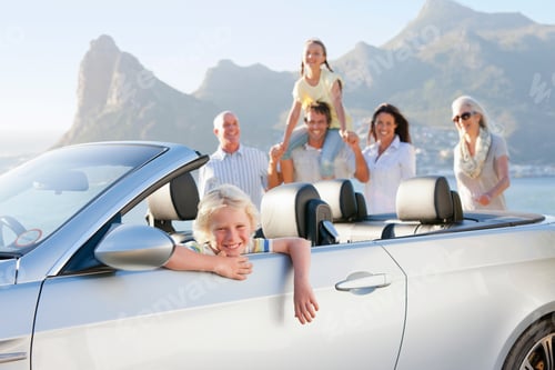 Preview: Portrait Of A Cute Little Boy Sitting In A Convertible And His Family Smiling And Looking At Him In