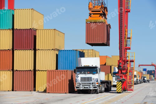 Preview: Gantry Crane Placing A Container On A Truck Beside A Huge Stack Of Other Containers