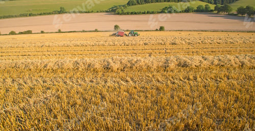 Preview: Extreme Wide Of A Rural Farm With A Tractor Baling Straw Over The Field.