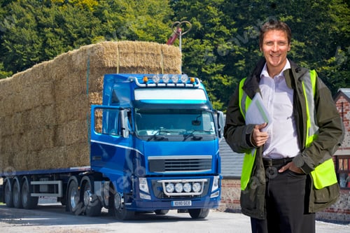 Preview: Man Standing By Weighbridge As Lorry Transports Straw Bales