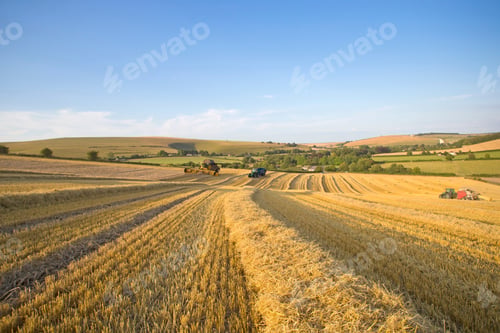 Preview: Extreme Wide Of A Rural Farm With A Tractor And A Combine Harvester Reaping Straw Over The Field.