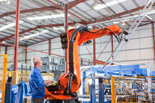 Preview: Worker Controlling Robotic Machinery Lifting Steel Fencing In Manufacturing Plant