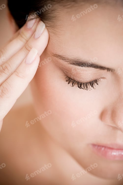 Preview: Portrait Of Young Woman With Eyes Closed And Fingers On Her Temple, Concentrating