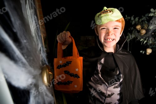 Preview: Boy In Costume At A Hallowe'En Party, Holding An Orange Party Bag