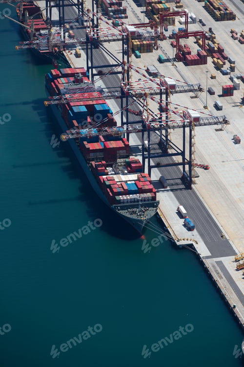 Preview: Vertical Shot Of The Aerial View Of A Container Ship Anchored At A Commercial Dock.