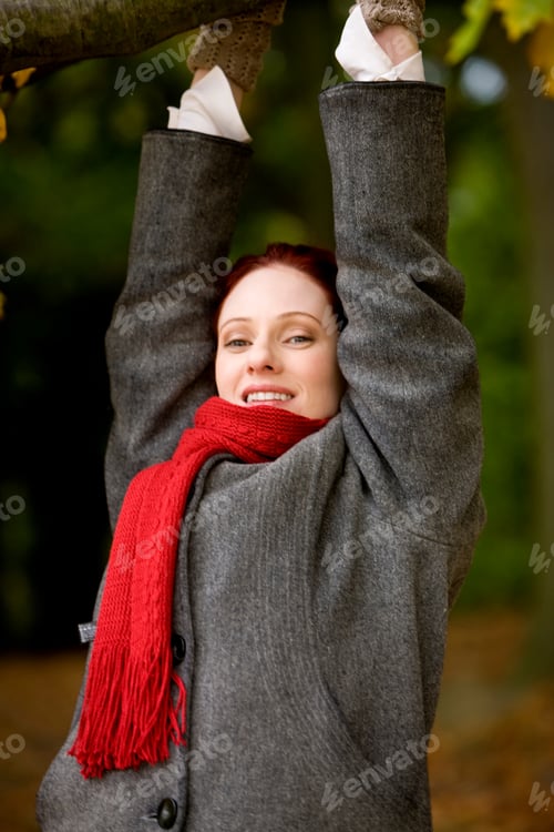 Preview: A Young Woman Hanging From A Branch Of A Tree