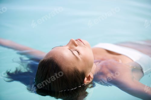 Preview: A Woman Floating In A Pool