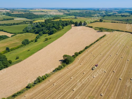 Preview: Aerial View Of Tractor Baling Hay In Field