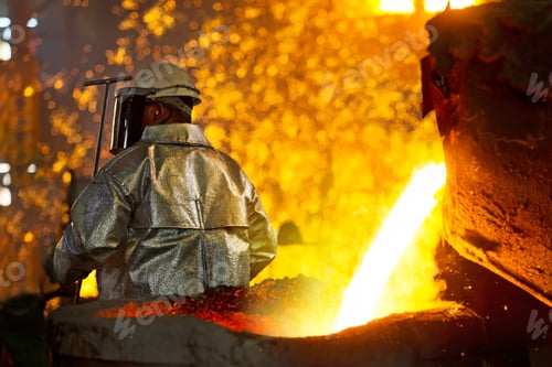 Preview: Worker In Protective Clothing Checking Molten Metal In Foundry