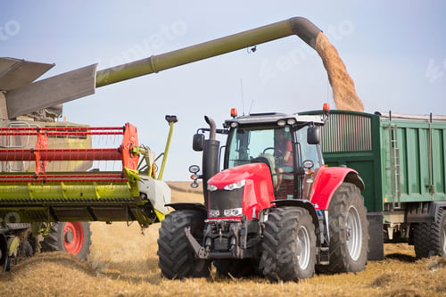 Preview: Combine Harvester Filling Trailer With Wheat At Harvest