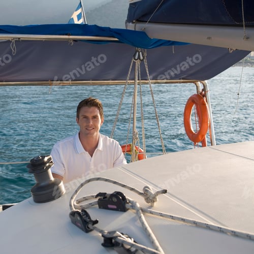 Preview: A Man Holding The Wheel Of A Sailing Boat