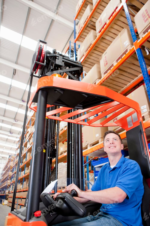Preview: Vertical Shot Of A Worker Operating A Forklift At The Production Line Of A Distribution Warehouse.