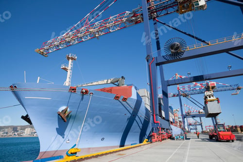 Preview: Cargo Ship Aligned Beside The Gantry Cranes At The Dockyard