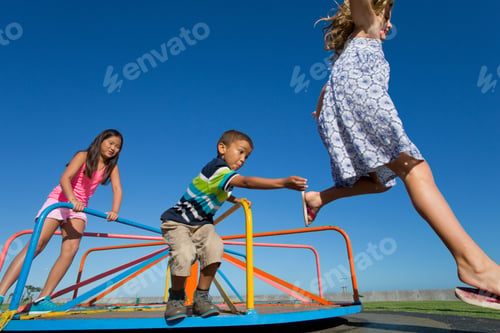 Preview: Children Jumping Off A Carousel In A Park