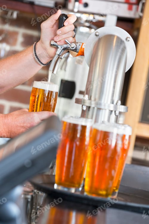 Preview: Close Up Of Bartender Pouring Pint Of Beer Behind Counter