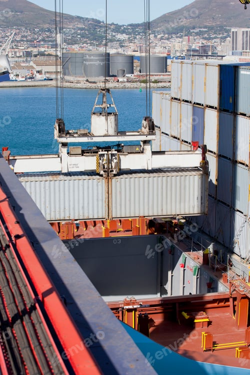 Preview: Vertical Shot Of A Crane Loading Cargo Containers Onto A Container Ship At A Commercial Dock.