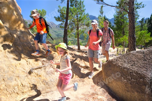 Preview: Couple With Backpacks Hiking Across A Mountainous Path With Their Children.