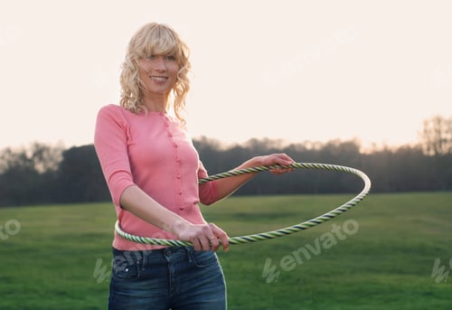 Preview: A Young Woman With A Hula Hoop Around Her Waist, Smiling