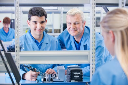 Preview: Medium Shot Of A Male Supervisor And Technician Smiling At The Camera While Assembling Circuit