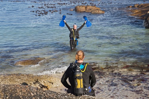 Preview: Woman Celebrating An Ocean Dive With Partner On Beach