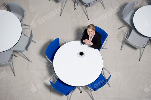 Preview: Businesswoman Working On Laptop At Table Of Office Canteen