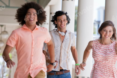 Preview: Wide Angle Portrait Of Smiling Friends Running Together In A Corridor
