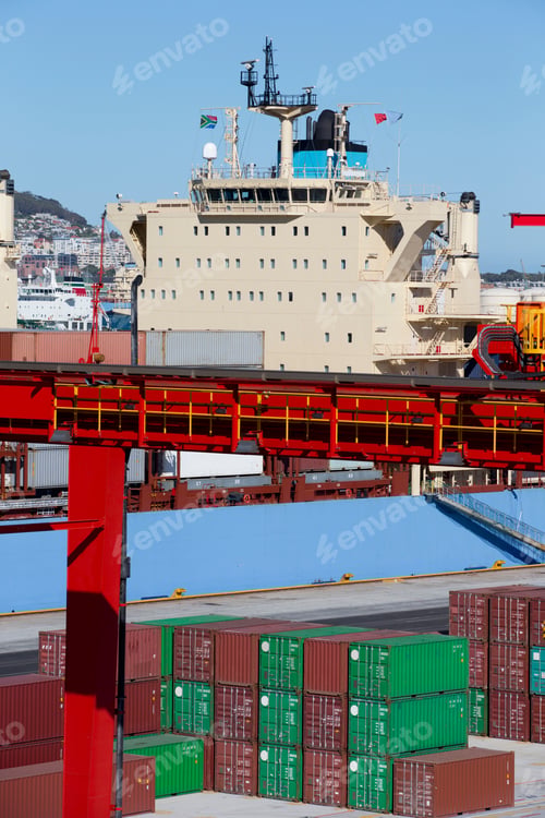 Preview: Vertical Shot Of A Crane And Stacked Cargo Containers At A Commercial Dock With A Container Ship In