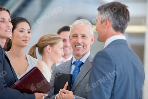 Preview: Portrait Of A Smiling Businessman Standing Among Co-Workers