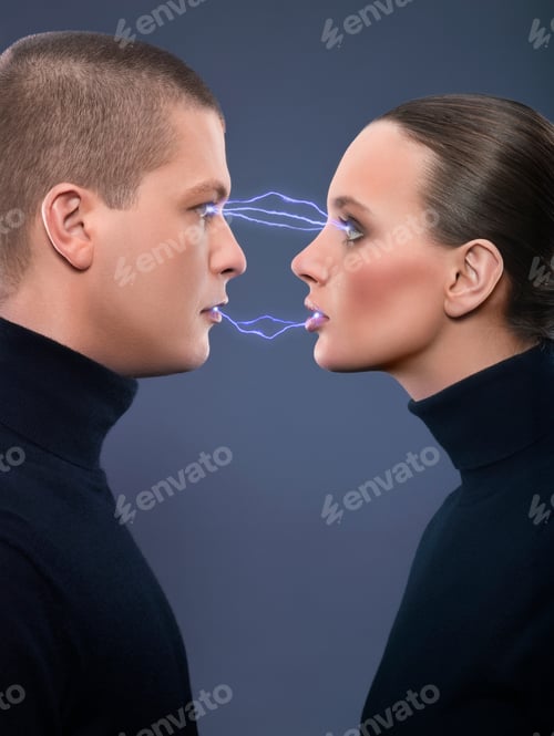 Preview: Man And Woman Staring At Each Other With Electricity Going To Each Other, Studio Shot