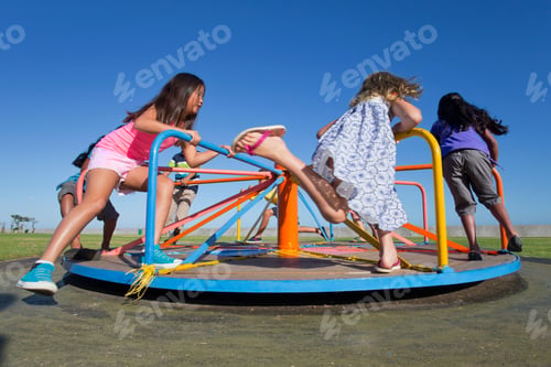 Preview: Children Playing On A Carousel In A Park