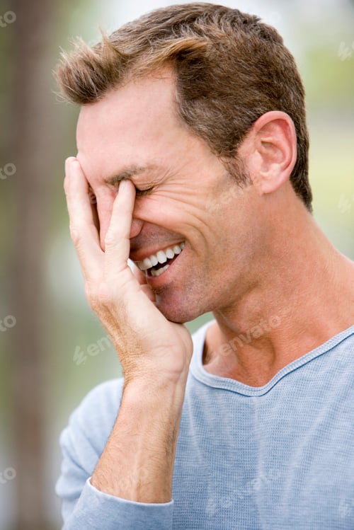 Preview: Mid Adult Man Laughing With Hand Over Face
