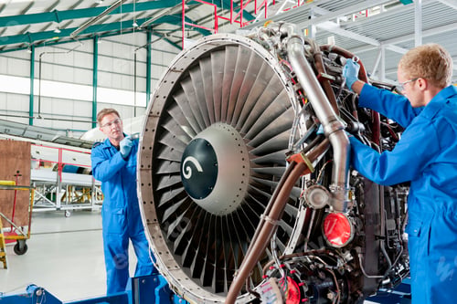 Preview: Medium Shot Of Engineers Inspecting The Turbine Engine Of A Passenger Jet At A Hangar.
