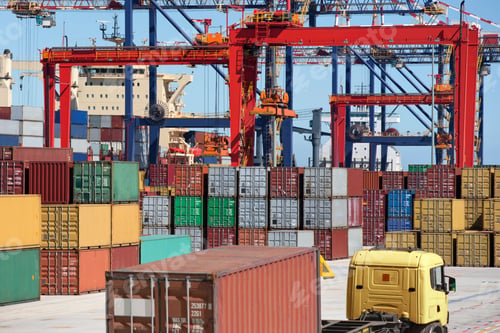 Preview: Cargo Containers And Cranes Alongside A Container Ship Moored At A Commercial Dock With A Truck In