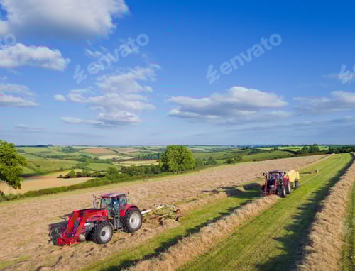 Preview: Aerial View Of Tractors Baling Hay In Field