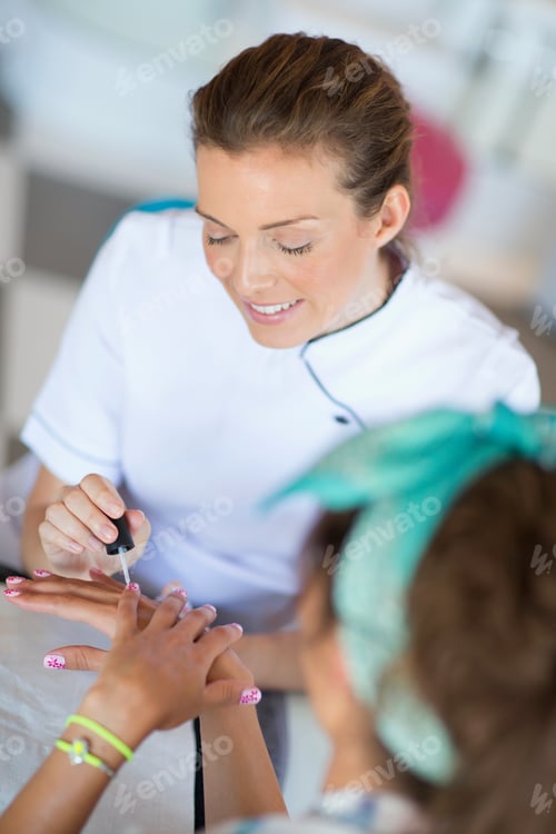Preview: Woman Applying Nail Polish to a Child's Hand