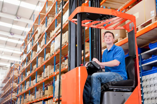Preview: Low-Angle Shot Of A Worker Operating A Forklift At The Production Line Of A Distribution Warehouse.