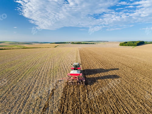 Preview: Aerial View Of Tractor Pulling Drill Sowing Seed In Field