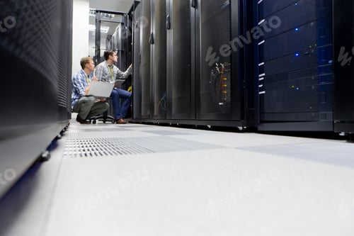 Preview: Wide Shot Of Two Technicians Working In The Data Center